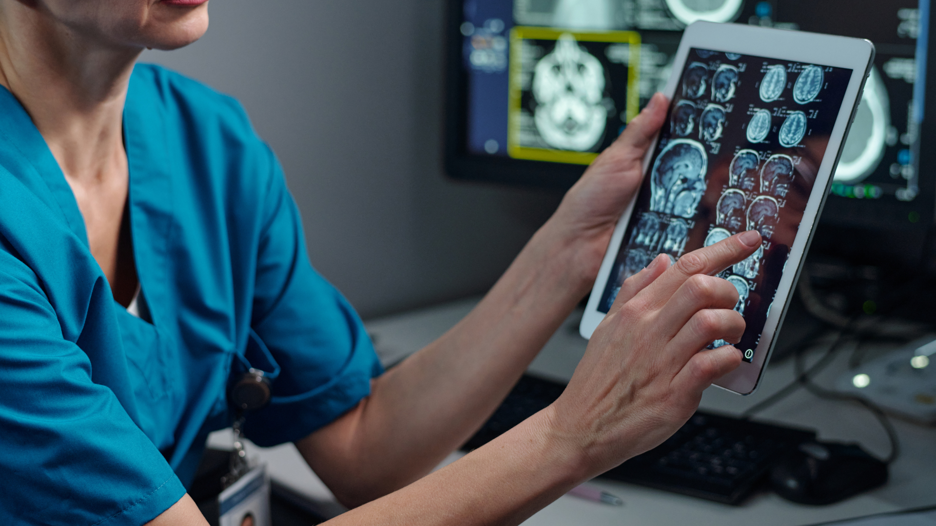 Doctor reviewing brain scan on tablet